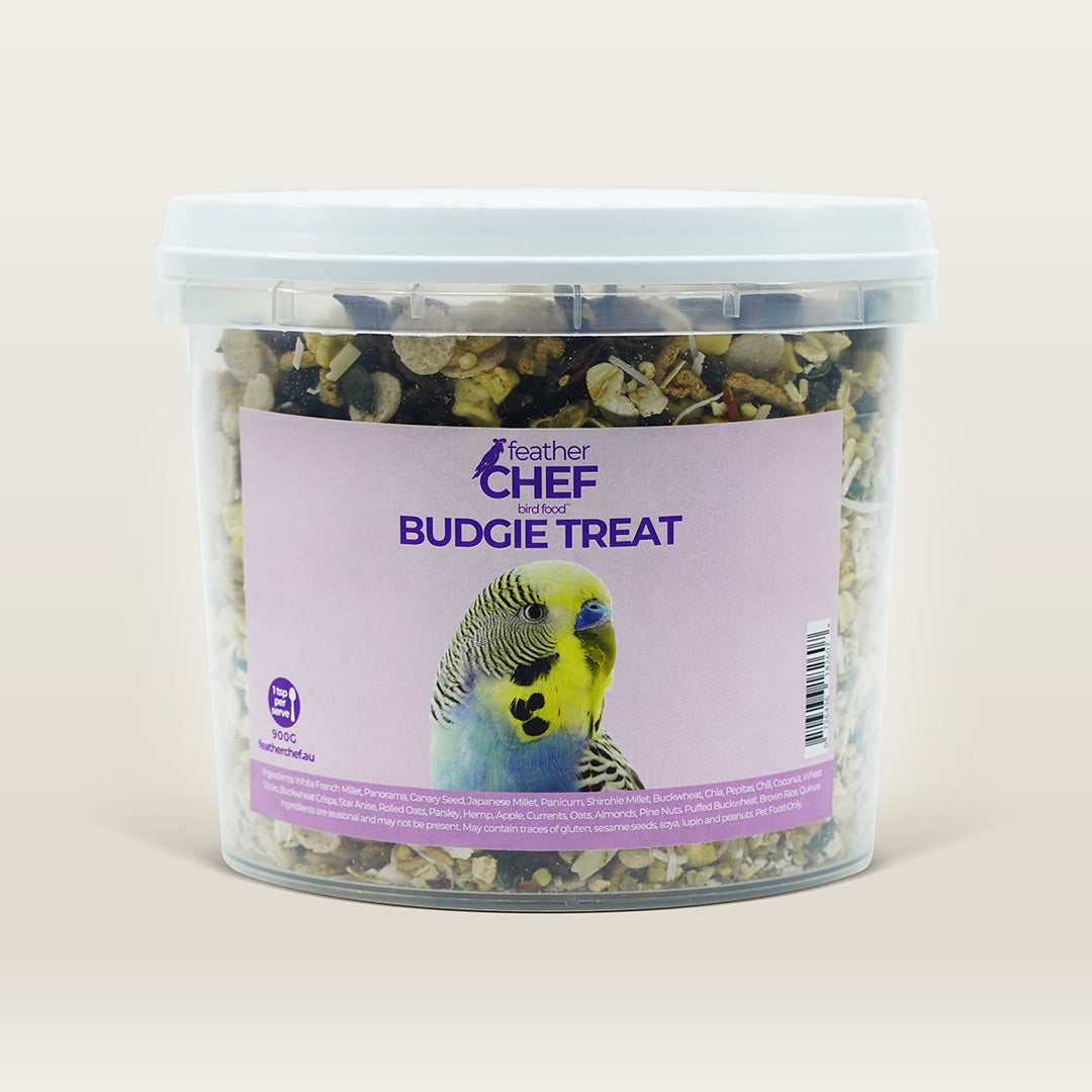 Container of Feather Chef Budgie Treats with a bird on the label against a beige background