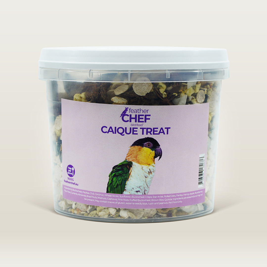 Container of Feather Chef Caique Treats with a parrot on the label against a beige background