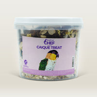 Container of Feather Chef Caique Treats with a parrot on the label against a beige background