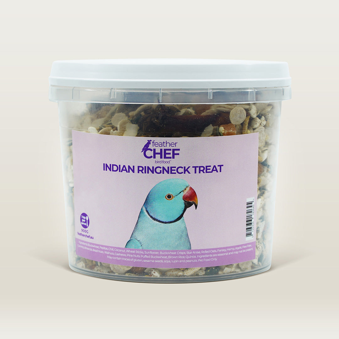 Container of feather chef Indian Ringneck treats with a parrot on the label against a beige background