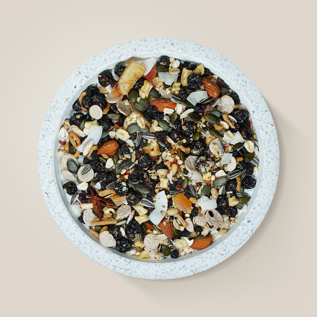 Feather Chef Small Macaw Treats in a bowl on a beige background