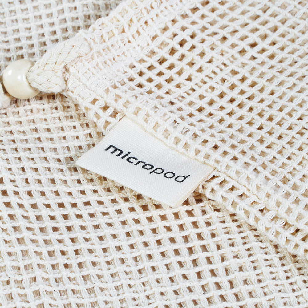 Close-up of a Micropod reusable produce bag, a sustainable way to store or carry microgreens alongside Seed Cube feeding routines.